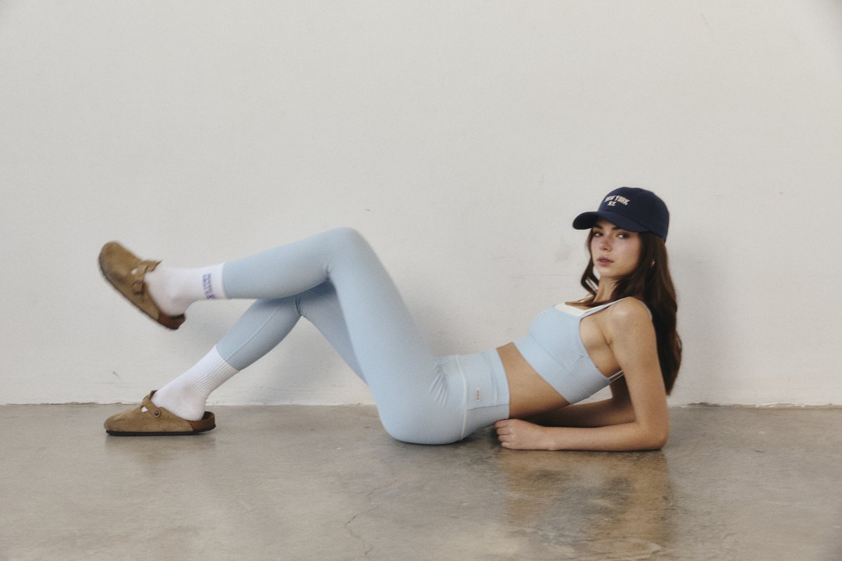 Model wearing a pale blue GYM AND SLIM set